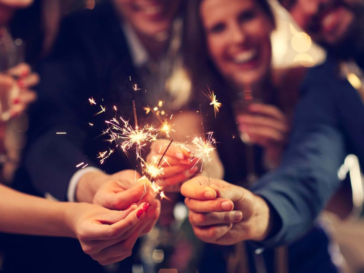 People holding sparklers at a party
