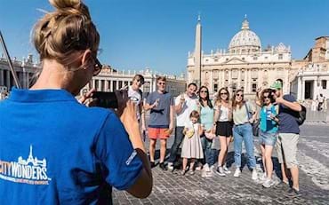 Tourists taking a picture in front of St. Peter's Basilica in the Vatican City