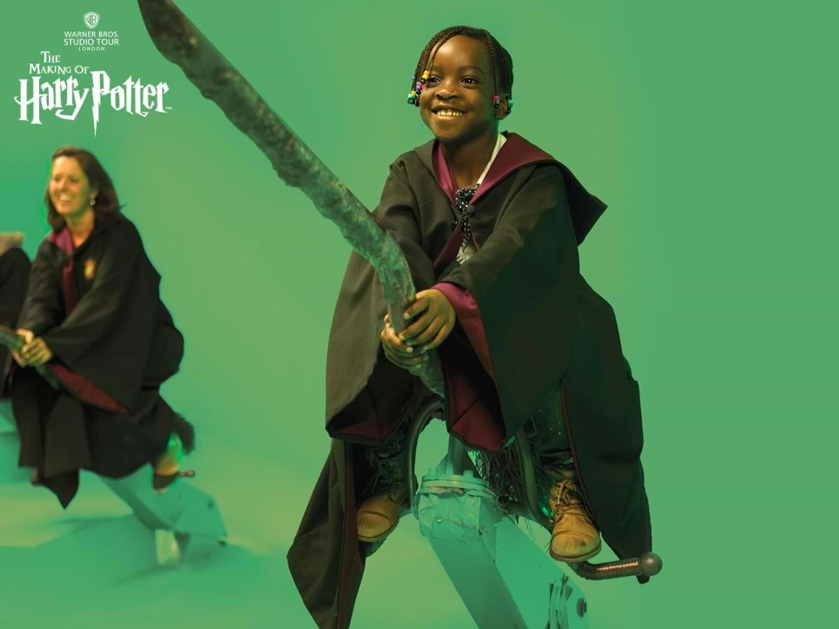 Kid sitting on a Wizard's Broom in a green rrom