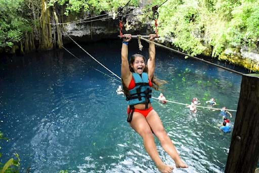 Girl doing zipline in a Cenote